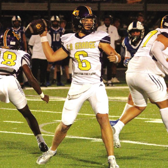 La Grange quarterback Clayton Cooper throws the football in Friday’s game. He ran for 200 yards and three touchdowns and threw for 113 yards and another score.
