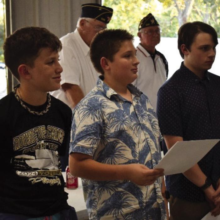 Carmine 4H students Bowen Williams, Grant Kieke and Peter Kieke (from left to right) participate in the Flag Disposal Ceremony held in association with the Carmine Chamber of Commerce Night Out on Oct. 2. As part of the ceremony, they presented the history of the Pledge of Allegiance, the American Flag and Call to the Colors.