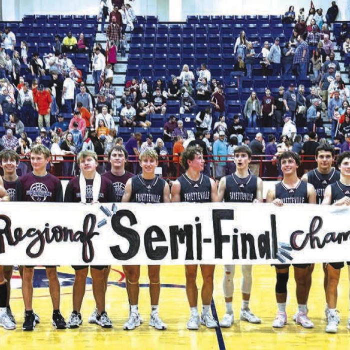 The members of the Fayetteville basketball team celebrate after Tuesday’s regional semifinal victory in the third round of the 1A playoffs in Madisonville.
