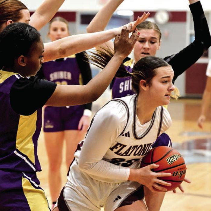 Flatonia’s Abbie Uzzell escapes trouble to get the pass off in Saturday’s district game with Shiner. Photo by Stephanie Steinhauser