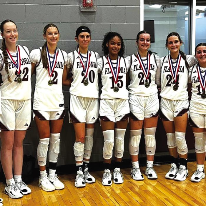 The members of the Flatonia girls basketball team pose with their championship medals after winning their home tournament Saturday.