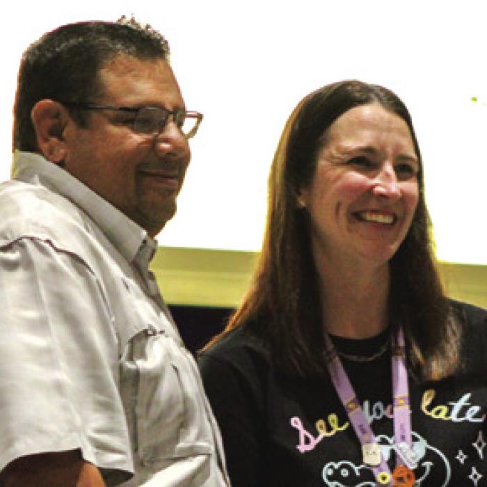 Kelli Tavarez, right, a teacher at La Grange elementary school, received $1,000 from Curt Harbers of Whataburger, right, for winning the What-a-Teacher Award, presented at Friday’s End of Year Convocation. Photo by Meadow Taylor-Marklin