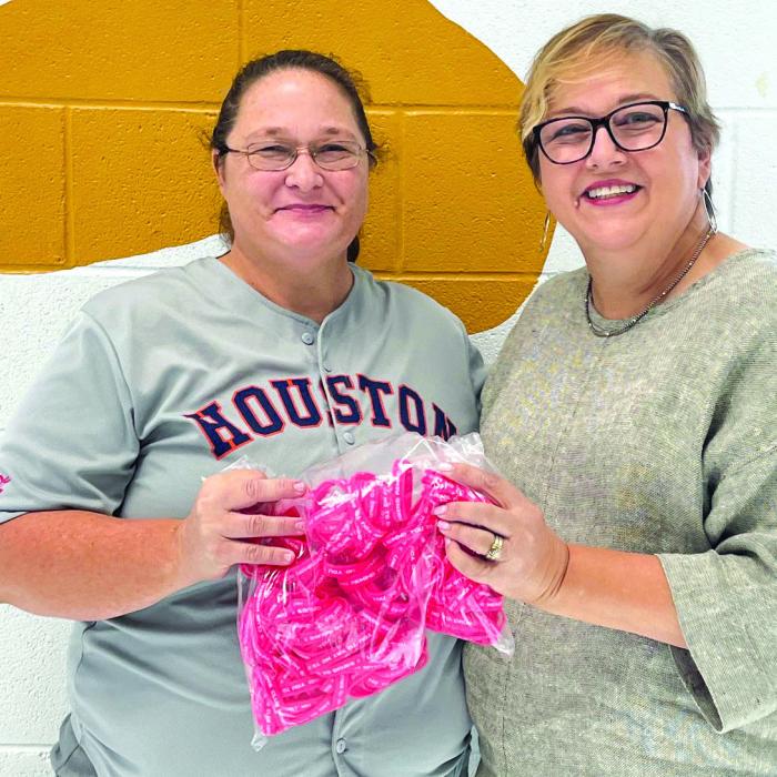 Carmine Lions Club donated wrist bands for Red Ribbon Week. Lion Lisa Mayer, right, presented them to Bonnie Pesch, a teacher at the Round Top-Carmine Elementary School. All students will receive a wrist band in recognition of this national campaign to encourage a drug-free life.