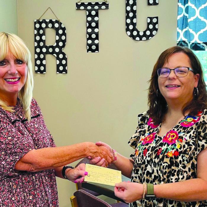 Carmine Lions Club recently made a donation to the Round Top-Carmine ISD for school supplies. Lion Diane Wied, left, presented the donation to Debra Foster, Counselor at RT-C.