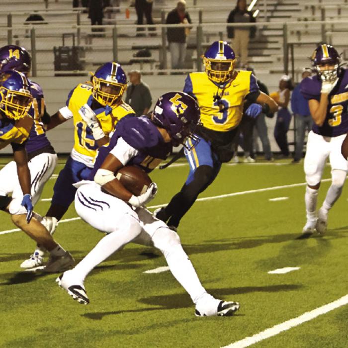 La Grange sophomore Dwodney Thompson is swarmed by Waco La Vega players as he tries to advance the ball Friday. Photo by Darrell D. Gest