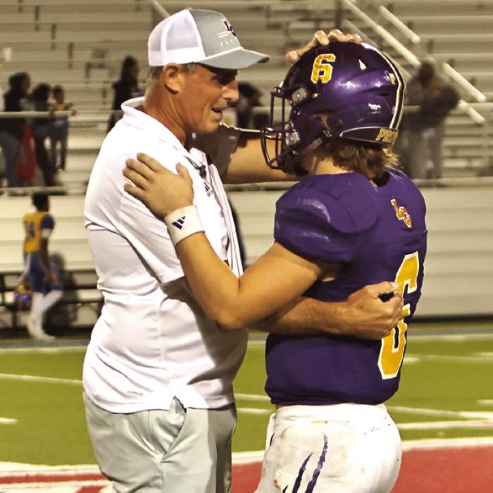 La Grange head football coach Kyle Cooper, shares a moment at the end of the game with his son, Clayton, the Leps quarterback, who was playing in his final game. Photo by Darrell D. Gest