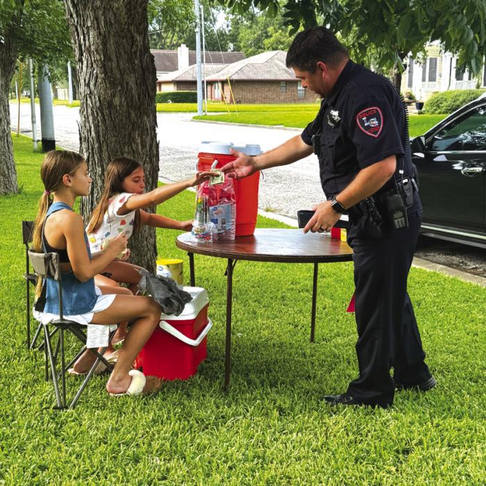 Girls Raise Money for Flood Victims at Lemonade Stand
