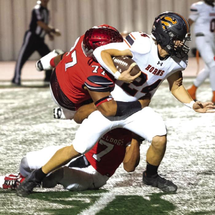 Mason Kunschick fights for yards as a pair of Three Rivers defenders try to bring him down.