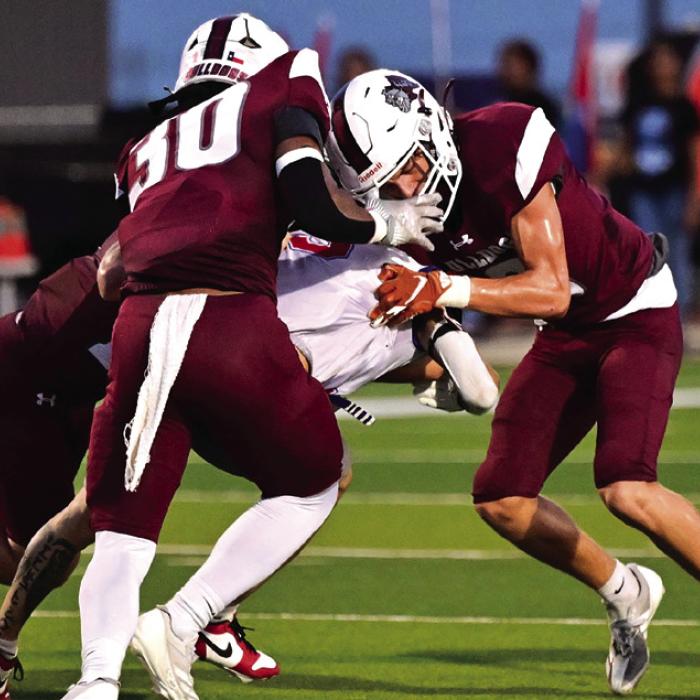 Bulldog defensive players Karen Scott, Richard Valdez and Kade Giese stop a Mustang from approaching Bulldog territory Friday. Photo by Stephanie Steinhauser