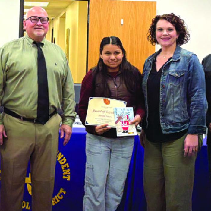 Nathalie Navarro, a 6th grader at La Grange Elementary was recognized at Monday night’s school board meeting for her Christmas card design. She is pictured here with her art teacher- Brittni Keilers, school board president-Gary Drab, principal-Dr. Regina Walker, and superintendent-Andy McHazlett.
