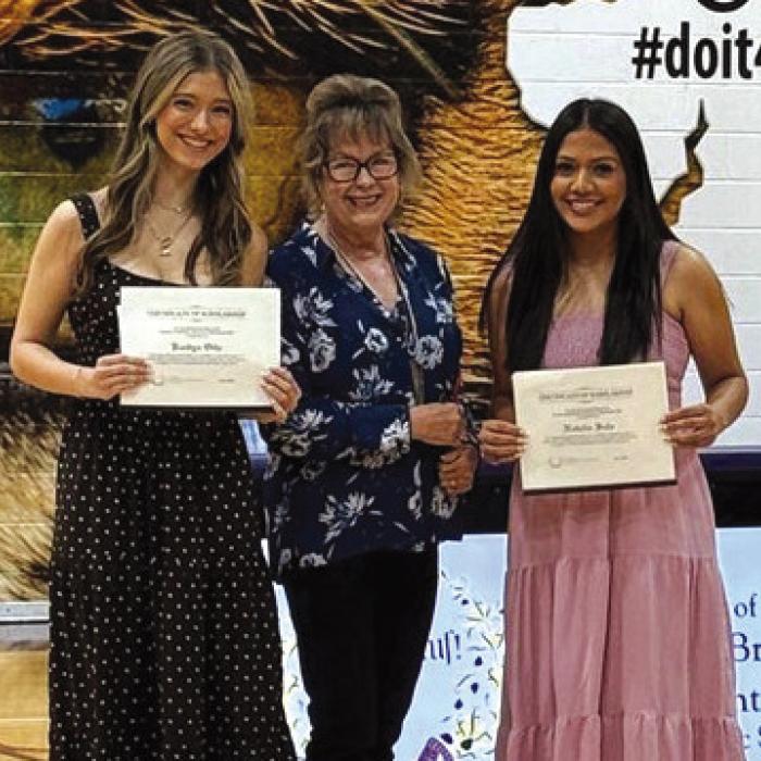 Kaedyn Otto (left) and Natalia Soto (right), both of La Grange High School, receive the 2025-2026 Friends of KBMH scholarship from Diana Wilson.