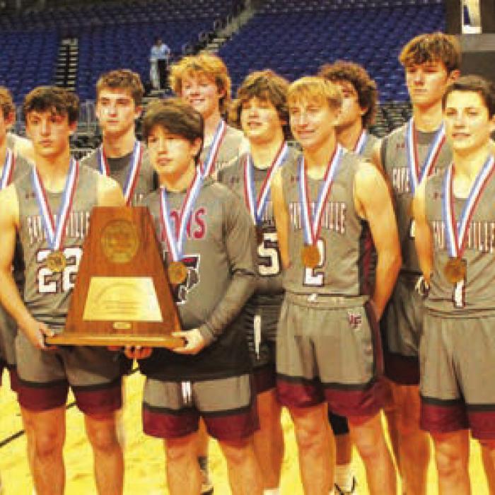 The members of the Fayetteville Lions basketball team pose with their state bronze medals and state semifinalist trophy after Thursday’s game.