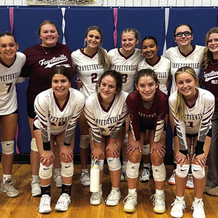 The members of the Fayetteville volleyball team pose after Thursday’s victory in the first round of the playoffs over Buckholts in Dime Box.