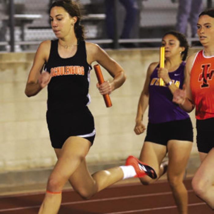Meredith Magliolo of Schulenburg, shown here in a relay Thursday, won the high jump.