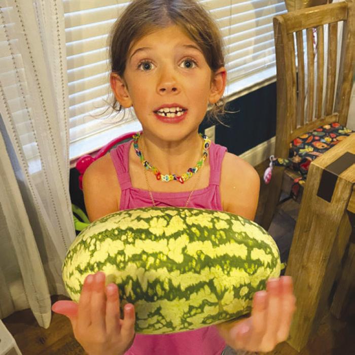 Frank and Kathy Chlumsky’s granddaughter Olivia with her birthday watermelon.