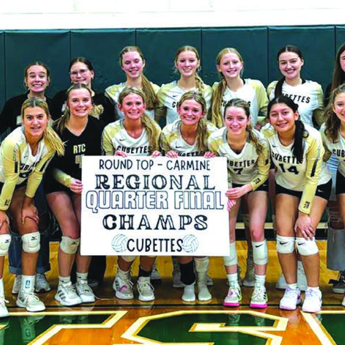 The members of the Round Top-Carmine volleyball team celebrate Tuesday’s third round playoff victory in Hunstville.