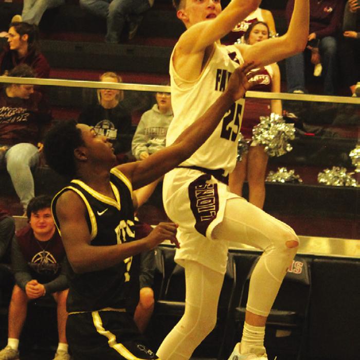 Fayetteville’s Easton Jaeger drives to the basket against the defense of Round Top-Carmine’s Tre’Veon Fischer. Jaeger had a team-high 17 points Friday. Photo by Jeff Wick