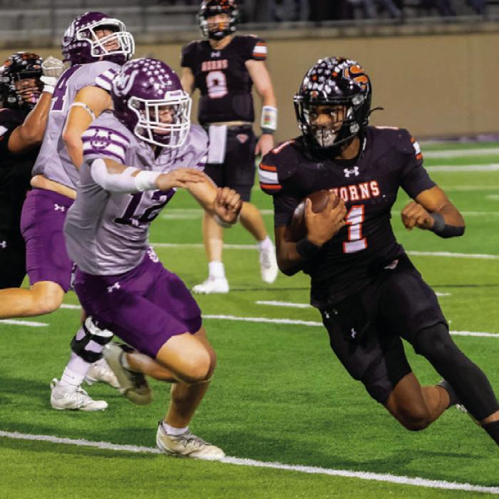 DaTerrion Houston evades a Mason tackler on a rush downfield. Photos by Andy Behlen