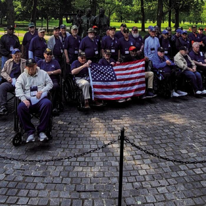 Members of the Honor Flight pose for a group photo at Arlington National Cemetery.
