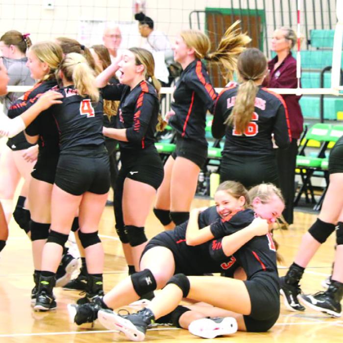 The members of the Schulenburg volleyball team storm the court for hugs all around after the final point of the regional title match Saturday in Brenham. Photos by Audrey Kristynik