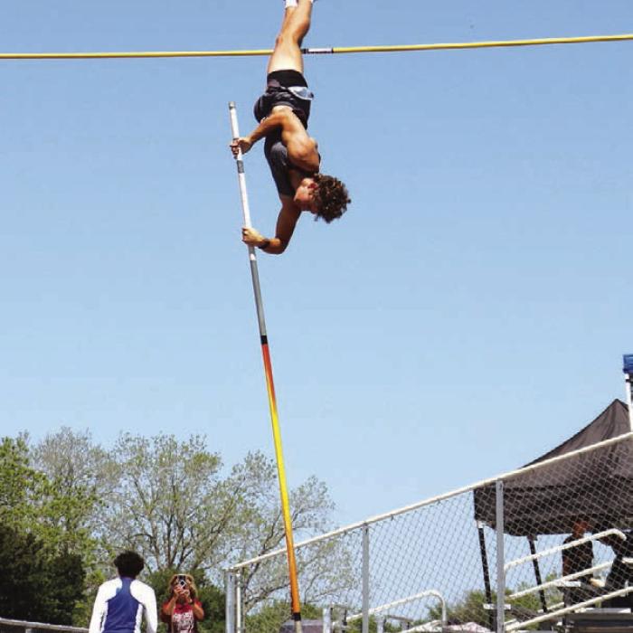 Fayetteville’s Lawson Fritsch soars to an area title in the pole vault. Photo by Ann Pape