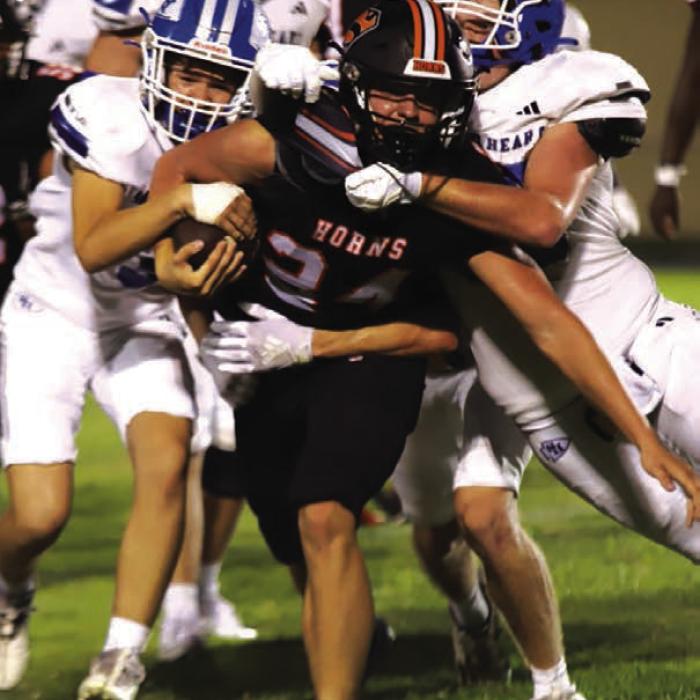 Schulenburg’s Mason Kunschick drags three Indians as he runs upfield in Friday’s victory. Photo by Audrey Kristynik