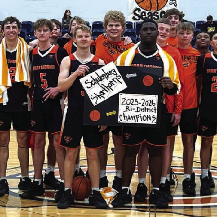 The Schulenburg boys basketball team celebrates their win Tuesday in Caldwell.