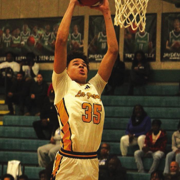 Above: La Grange’s Brandon Mathis goes up for a dunk in the first quarter Monday. Below: La Grange’s Cordale Knapik, shown here shooting, scored a team-high 17 points Monday. Photos by Jeff Wick