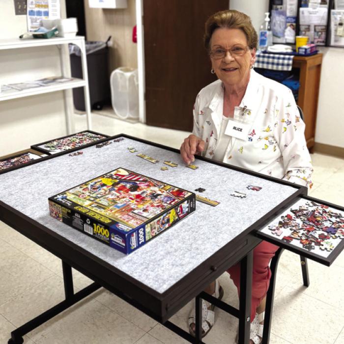 Alice Fajkus is happy to have a puzzle table to work at, in Schulenburg Senior Connections.