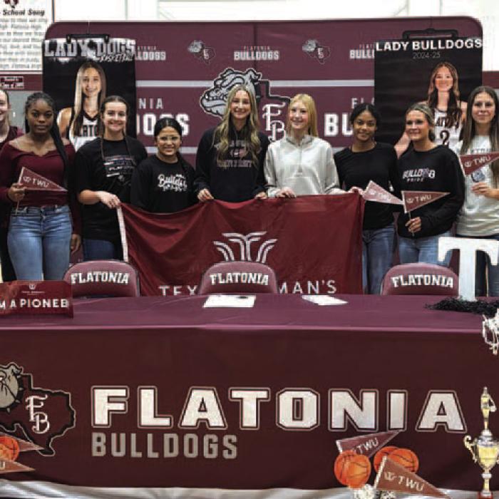 Summer Sodek, center in black, is joined by her teammates at her signing ceremony last week in Flatonia.