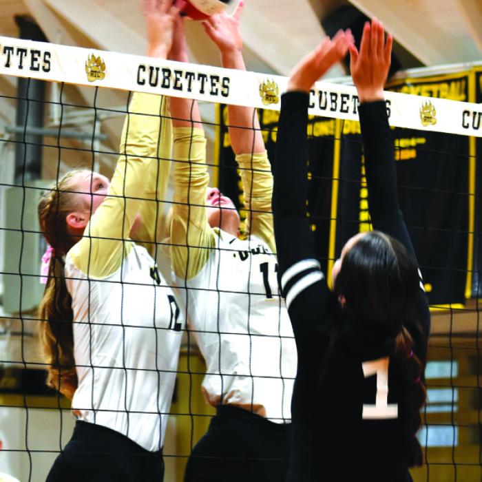 Round Top-Carmine’s Madison Markwardt and Jessica Rohde join forces at the net in Tuesday’s victory over Fayetteville. Photo by Paul Kipp