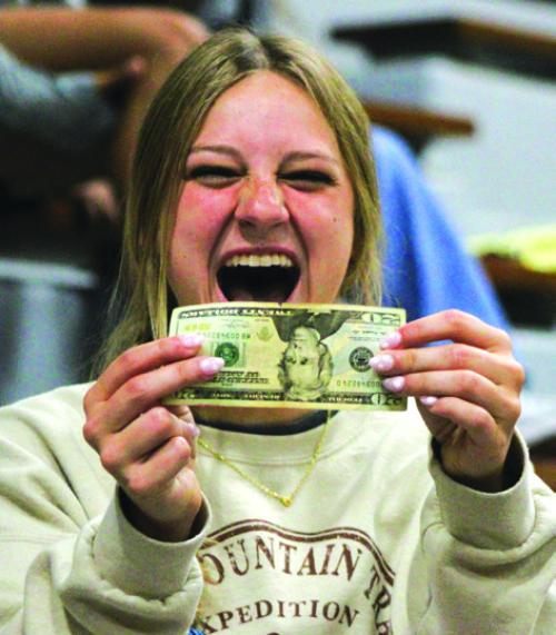 Senior Bailey Swisher reacts to finding a $20 bill in the letter she sent herself as an 8th grader. Photo by Meadow Taylor-Marklin