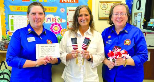 VFW Auxiliary 5254 of La Grange presented U.S. flags, “Buddy” poppies, and Veterans Day coloring books to St. James Episcopal and First Light pre-school campuses for Veterans Day activities. From left, VFW Auxiliary secretary/historian Becky Leer, Pre-School Director Laurie Krupala, and VFW Auxiliary Jr. Vice President Elizabeth Kallus.