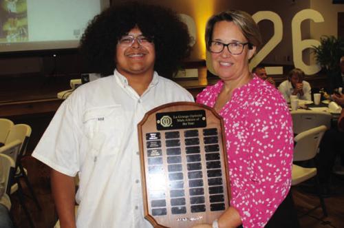 Erick Guevara, left, was the winner of the Charles Koether Male Athlete of the Year Award, presented by the La Grange Optimist Club. Misty Touchet, right, presented the award.