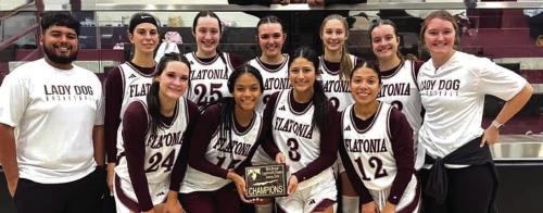 The Flatonia girls hold their championship trophy from the Fayetteville Classic.