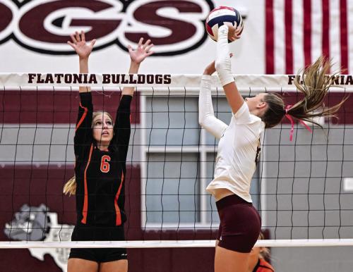 Schulenburg’s Clare Magliolo, left, and Flatonia’s Summer Sodek battle at the net in Saturday’s district volleyball match. Photo by Stephanie Steinhauser
