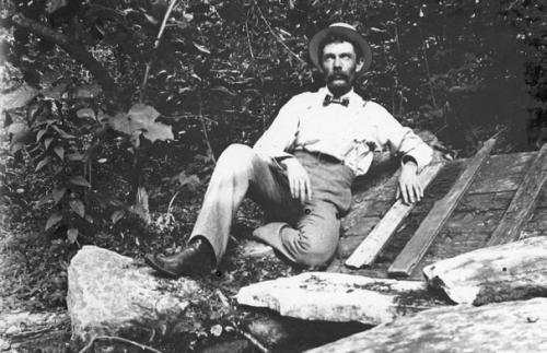 Labeled “Bluff Spring,” Frank Hausmann is shown on the farm belonging to his father, Franz Hausmann. They put the rock ledge over the springs and then the wooden cover and used it like a spring house to keep food cool. Photo courtesy of the Fayette Heritage Museum &amp; Archives