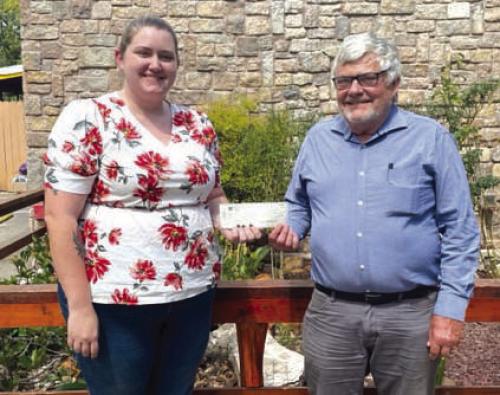 Pictured are Children’s Advocacy Center Executive Director Meagan Webb (left) accepting the donation from Steve Hillhouse.