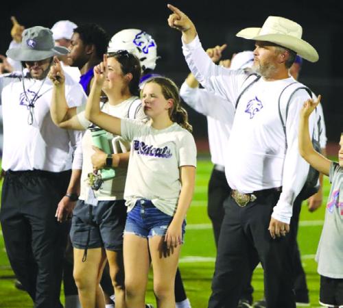 Coach Clay Ferguson (right) is shown here with his family after a football game in Elgin, where he served as defensive coordinator. Schulenburg I.S.D. hired him last week as the new athletic director and head football coach.