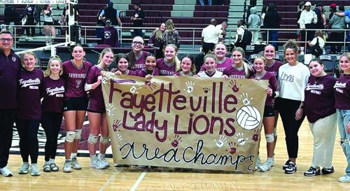 The members of the Fayetteville volleyball team celebrate their area round victory in Waller Tuesday over Hull-Daisetta.