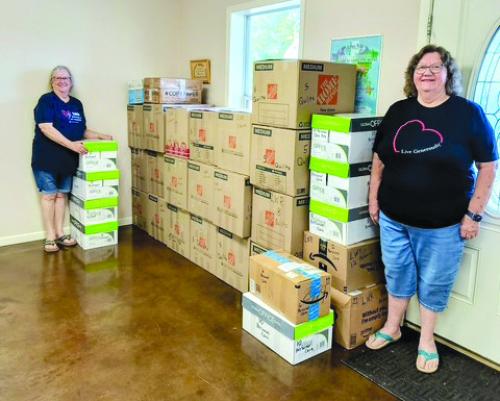 Martin Luther Lutheran Church Women of the ELCA packed the shipment for Lutheran World Relief on Oct. 23. Pictured are Leonita Sanders, left and Colette Wunderlich, right, with the thirty-two boxes to be shipped on Nov. 1. Also helping pack 109 quilts, 32 school kits, and 72 personal care kits were Diana Wunderlich, Nancy Eilers, and Joys Baird.