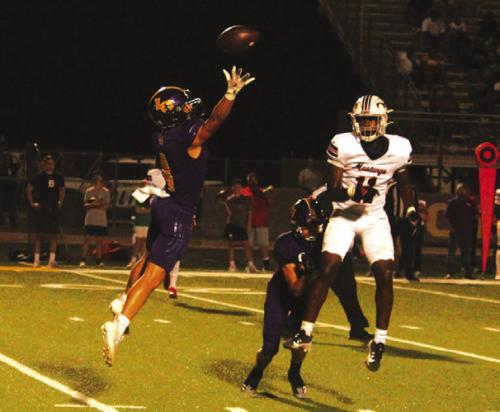 La Grange’s Eli Gillum leaps to try to make a play on an errant pass by Madisonville Friday.
