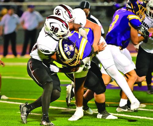 Koren Scott (#30) and Richard Valdez (#56) bring down a Weimar ball carrier in Friday night’s game. Photo by Stephanie Steinhauser