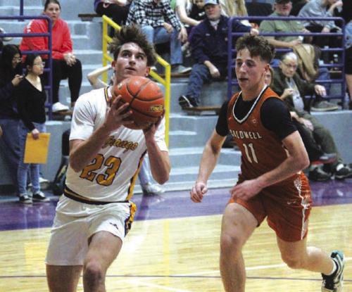 La Grange’s Mason Kleiber outraces a Caldwell player to the basket for two points Tuesday. Photo By Jeff Wick