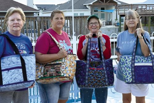 The ladies who completed their tote bags on the quilt retreat – Marian Tajchman, Kim Bonewald, Tricia Griste and Nancie Blair.