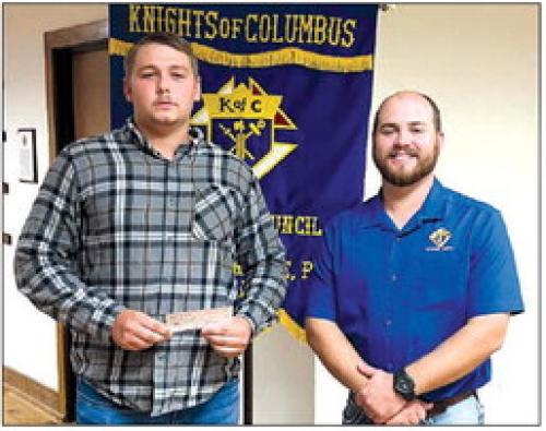 Receiving a Knights of Columbus Scholarship in honor of deceased member Monsignor Harry Mazurkiewicz is Michael Kosler.