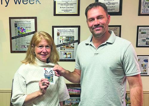 Jennifer Matocha Gillie was the winner in last week’s reader football contest, not only picking all 10 winners but beating out two other perfect ballots in the score prediction tiebreaker. She is shown above left, accepting her $100 from Record editor Jeff Wick.