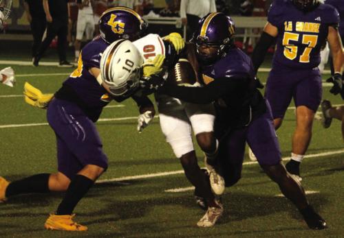 La Grange’s Holdyn Cooper, left, and Jaylances Johnson, right. sandwich this ballcarrier Friday. Photo by Jeff Wick