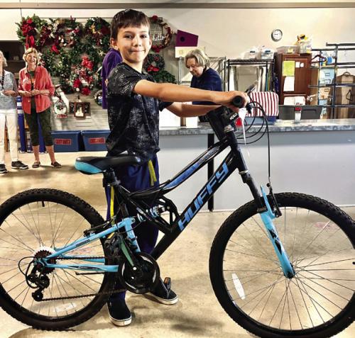 Last month, Second Chance Emporium issued a record amount of grants to a dozen local non profit groups. Max Sanchez of Ammannsville did his part, buying this snazzy mountain bike at the store last week. Photo by Bill Bishop
