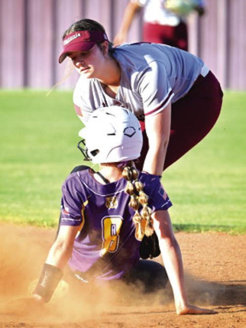 Flatonia’s Abbie Uzzell takes the throw from catcher Katie Templeton to tag out a Lady Wildcat attempting to steal. Photo by Stephanie Steinhauser